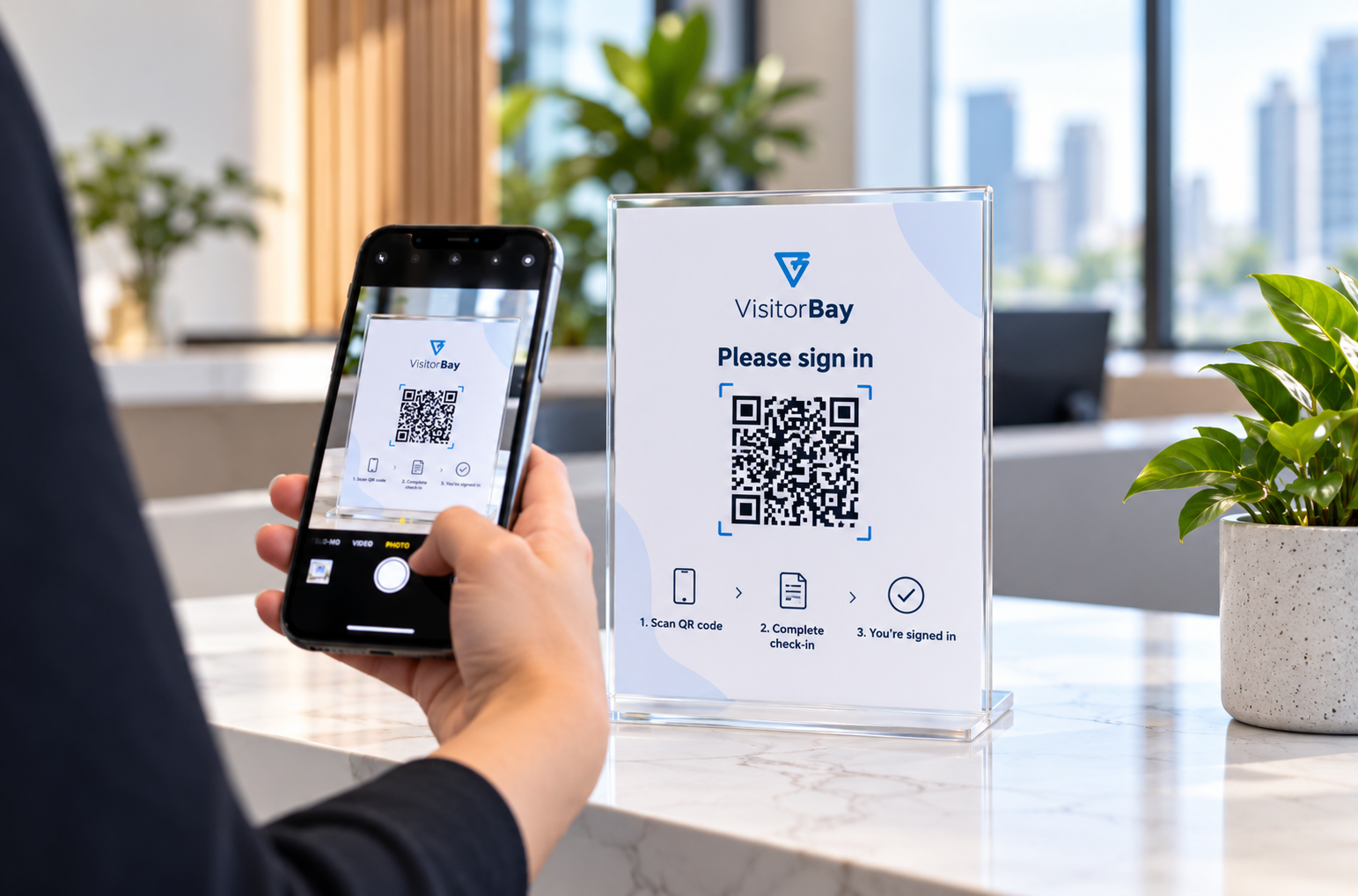 Visitor scanning a VisitorBay QR code reception sign with a smartphone, without a check-in tablet