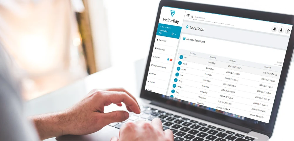 Actual VisitorBay administration portal displayed on a laptop